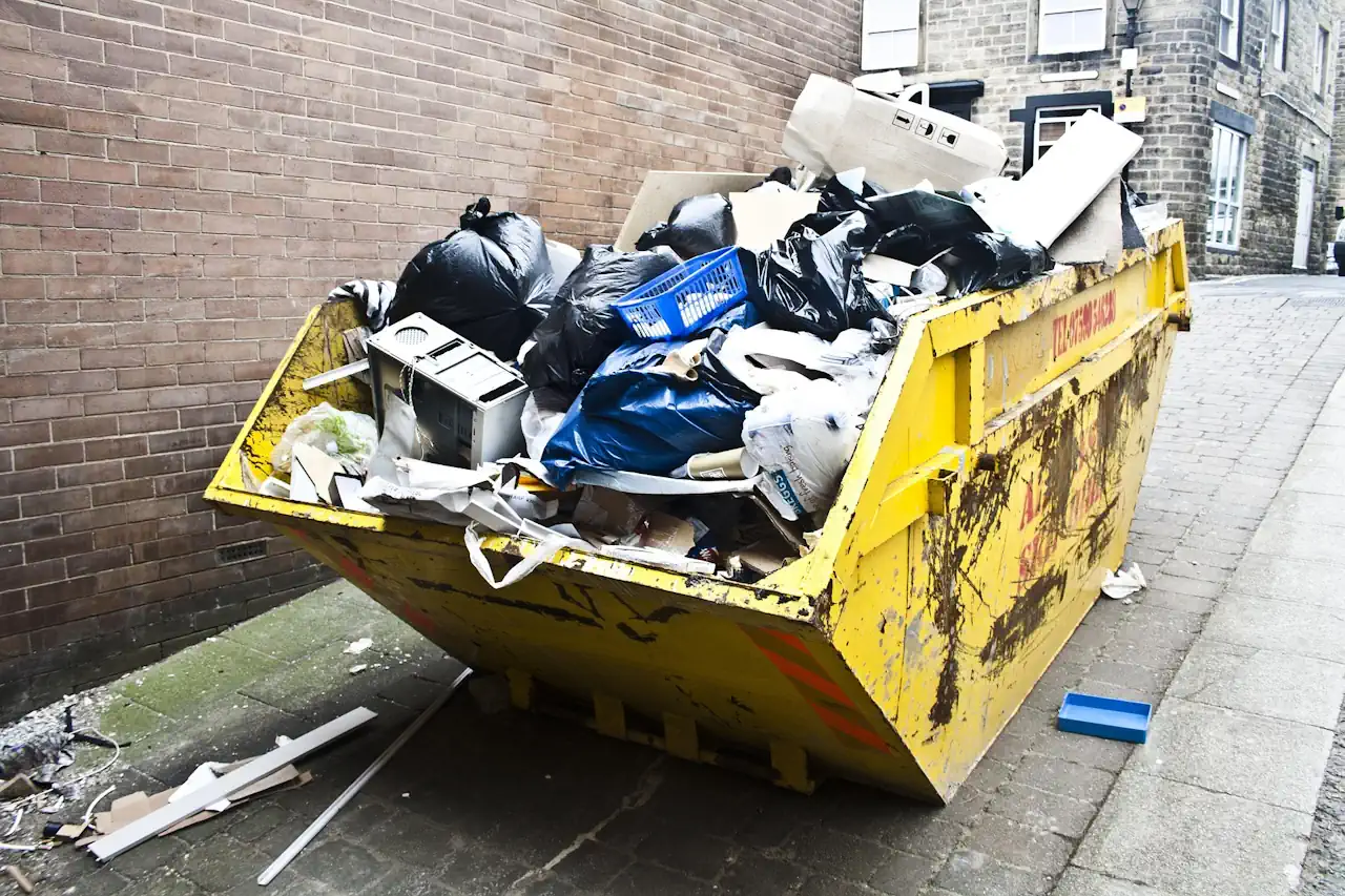 Skip in a street with restricted items